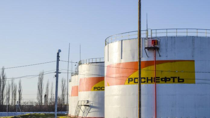 Reservoirs with fuel at the oil depot of Rosneft Tanks in the light of the setting sun