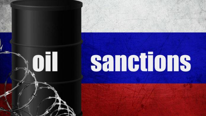 Oil sanctions against Russia barrel barbed wire Russian flag background