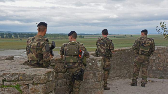 Four French soldiers from behind on Mont Saint Michel