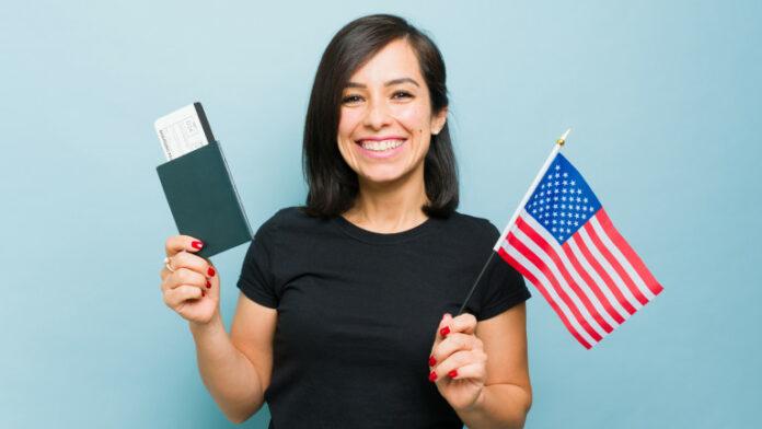 Gorgeous woman feeling patriot with the passport and US flag