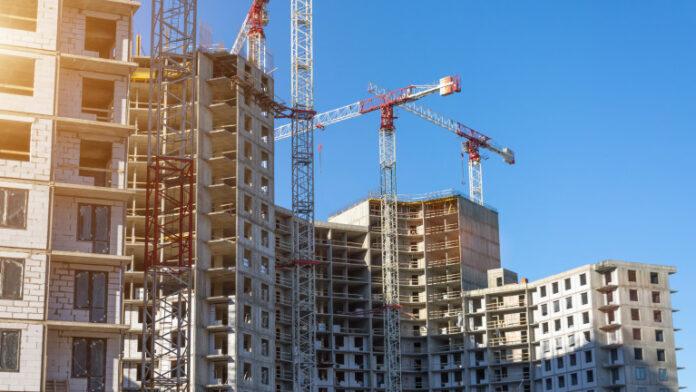 Crane and building construction site, look up view